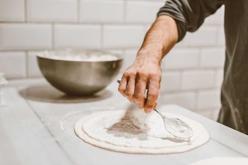 pizza lucs kitchen team preparing handcrafted pizzas